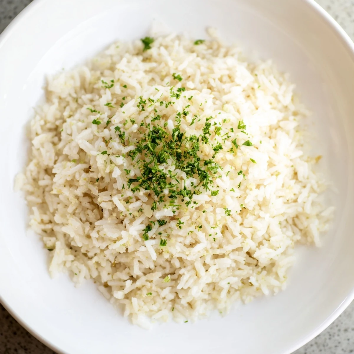 A close-up of golden Garlic Butter Rice, showcasing the garlic and flavorful broth infusion.