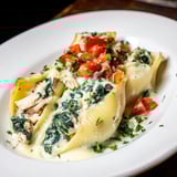 A close-up of High-Protein Cottage Cheese Alfredo Christmas Shells, showing creamy Alfredo sauce and turkey.