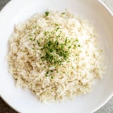 A close-up of golden Garlic Butter Rice, showcasing the garlic and flavorful broth infusion.