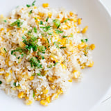 A steaming bowl of vibrant Mexican Street Corn Rice topped with cotija and fresh lime zest.