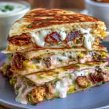 Cinco de Mayo Street Corn Quesadillas with Chipotle Crema, featuring roasted corn, melted cheese, and smoky chipotle drizzle.