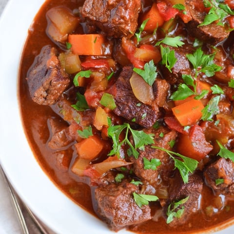 Rich Smoked Paprika Beef Stew simmers to perfection, ready to serve with crusty bread.