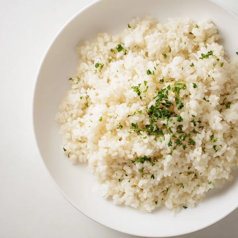 Steaming Garlic Butter Rice, fluffy and aromatic, ready to serve as a delicious side.