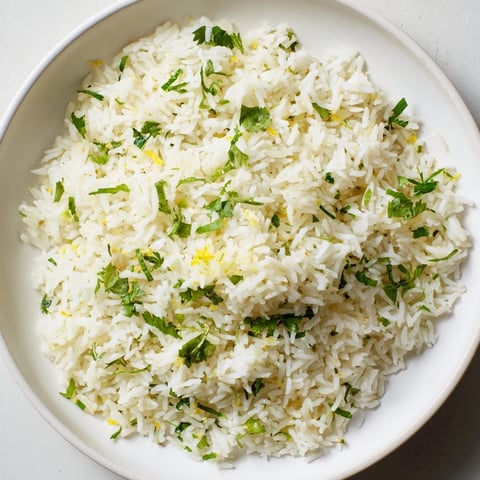 Fluffy Cilantro Lime Rice glistening with lime, perfect for serving with flavorful tacos.