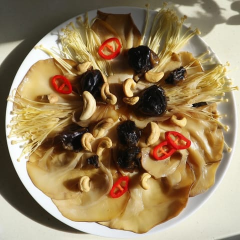 A visually appealing Umami Bomb Asian Delight recipe, showcasing mushrooms, seaweed, and dipping sauces on a platter.