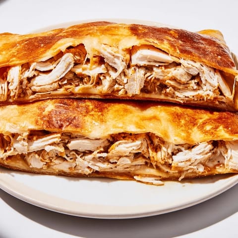 A savory Leftover Pizza Grilled Cheese with perfectly toasted bread and a cheesy chicken filling.