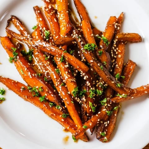 Golden brown Maple Mustard Roasted Carrots, expertly roasted, ready to be served and enjoyed.