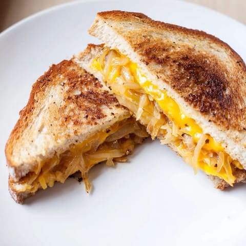 Rustic sourdough bread, grilled golden brown, filled with caramelized onions and Gruyère in grilled cheese.