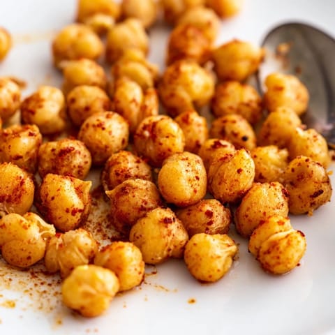 A bowl of crunchy Crispy Chickpea Snack with a bold spice blend, served warm as a healthy vegan treat.  