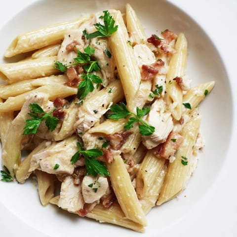 This hearty Creamy Chicken Bacon Penne features golden sautéed chicken and smoky bacon in a velvety cream sauce.