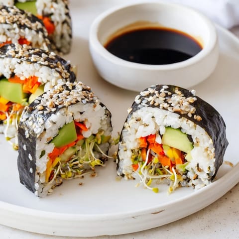 These nori rolls showcase vibrant cucumber, avocado, and sprouts, ready for dipping in soy sauce.