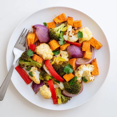 Freshly roasted Anti-Inflammatory Turmeric Roasted Vegetables served warm, garnished with cilantro and a lemon drizzle for a nourishing side dish.  