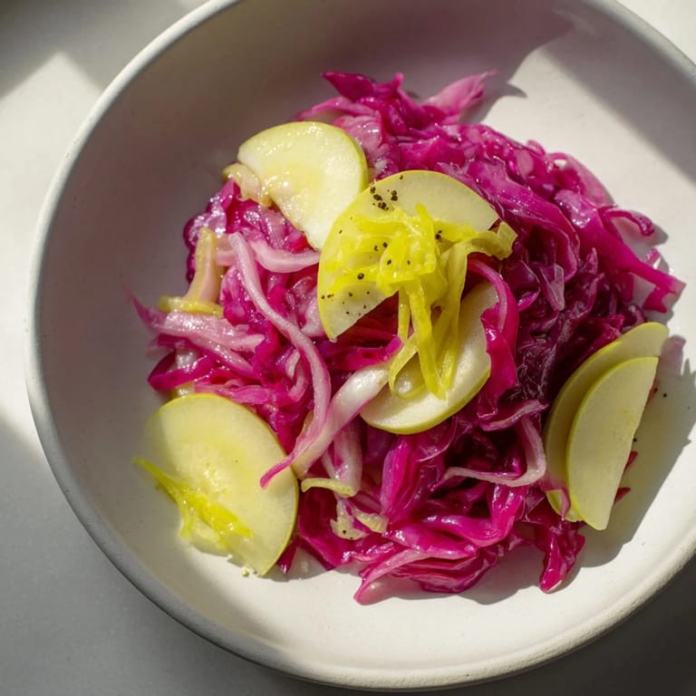 Tender Bavarian Red Cabbage and Apple, simmered with vinegar and spices, is a colorful and tangy German delight.