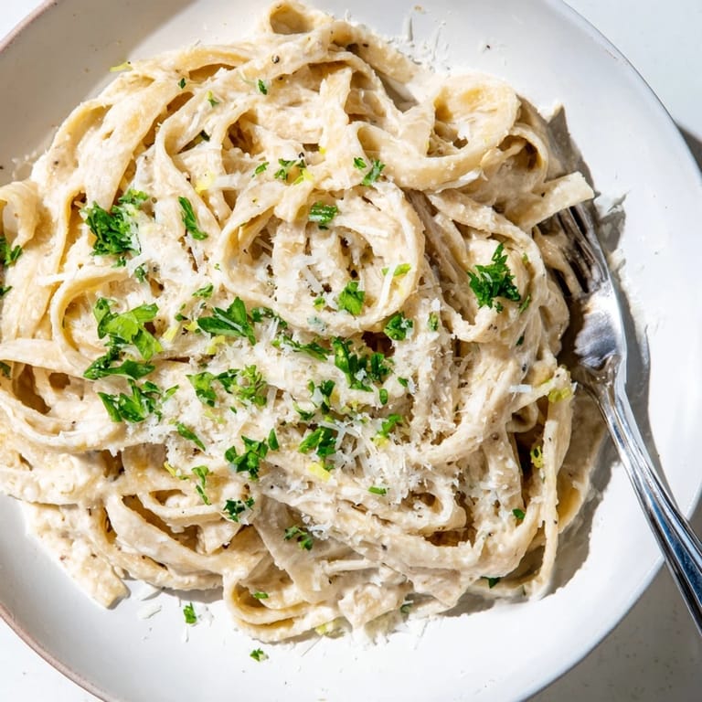 This Skinny Alfredo features garlic parmesan flavors over the perfectly cooked pasta, ready to enjoy.
