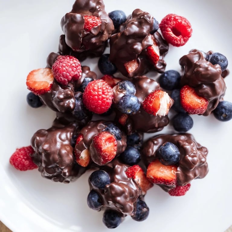 A close-up of berry-filled chocolate yogurt clusters: a refreshing, homemade treat.