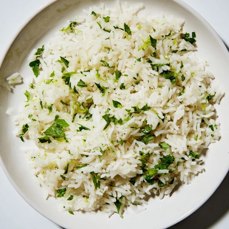 Steaming bowl of Cilantro Lime Rice, a fragrant and easy Mexican side paired with grilled chicken.