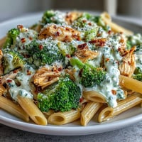 Bright broccoli florets and juicy rotisserie chicken mingle in a creamy Greek yogurt sauce over whole-wheat penne.
